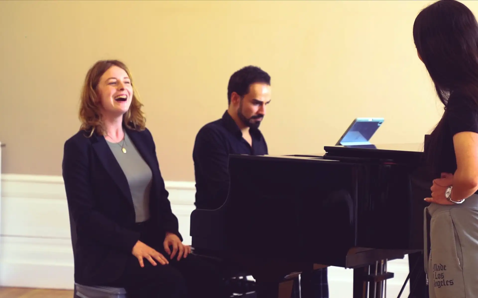 Student laughing during a singing lesson at the piano